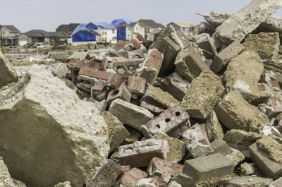 Rubble from destroyed homes remains heaped up in neighborhood where other houses undergo repair during recovery more than 4 months after a tornado in Washington, Illinois, USA
