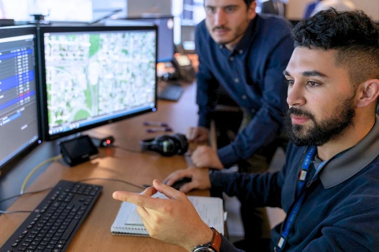 Operations team reviewing system data and AI-assisted insights together to verify information and support decision-making