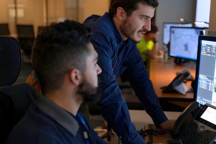 Team members working together to manage communication systems and ensure reliable operations across a property