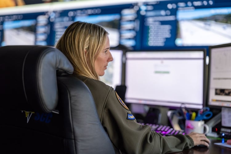 Communications specialist monitoring emergency responder radio coverage systems and network performance