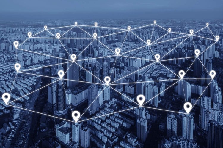 Aerial view of a city with interconnected location pins and network lines, representing expanded service coverage and connected operations across multiple locations.